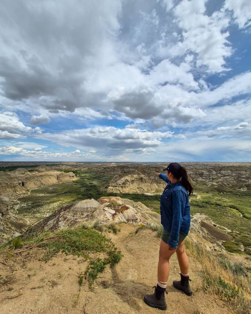 Alina at the UNESCO Overlook in Dinosaur Provincial Park pointing into the distance.