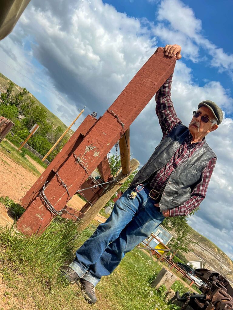 Bob dressed in blue jeans, a red flannel shirt, and a leather vest.
