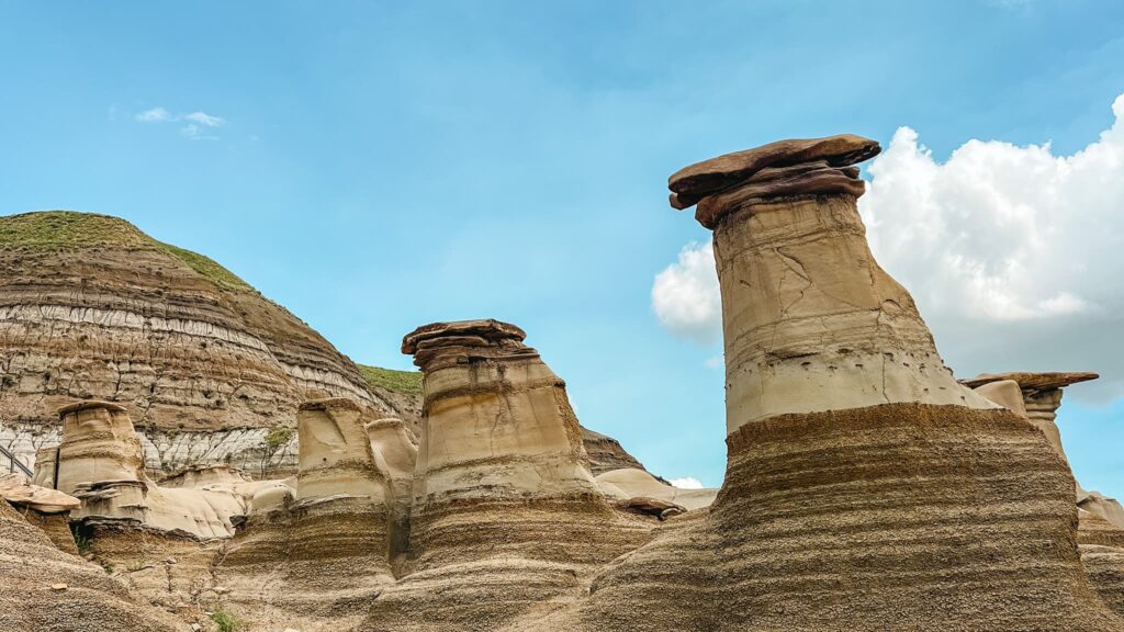 Willow Creek Hoodoos. There are 6 hoodoos visible. Natural stone columns with a mushroom shaped cap.
