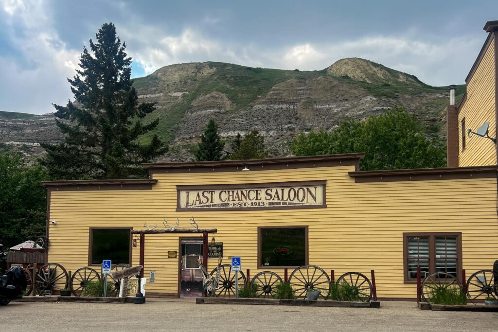 The outside of Last Chance Saloon. It is an old building with yellow slat siding.