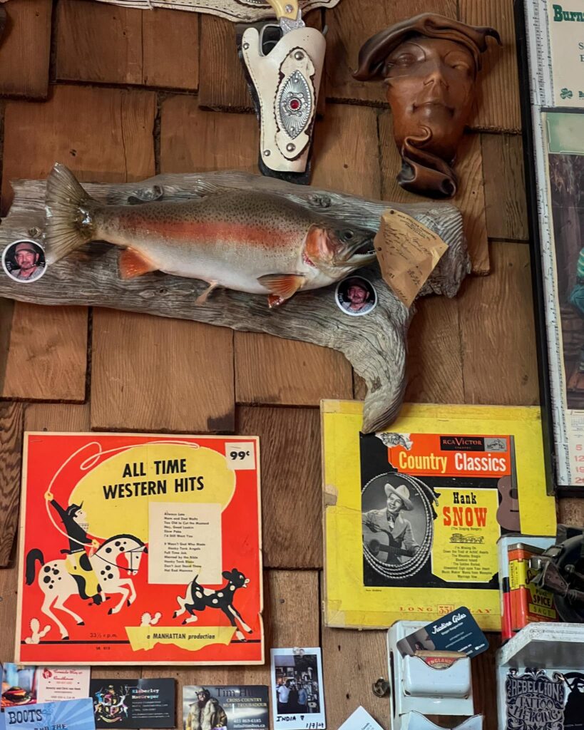 Inside the Last Chance Saloon. There are many old objects on the wall like a mounted fish and country western vinyls.