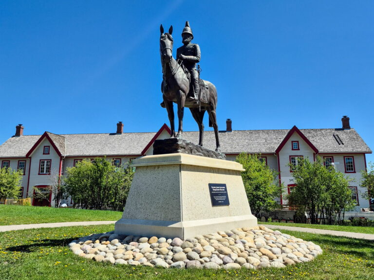 A statue of Colonel James Macleod on a horse in front of the Confluence building in Calgary.