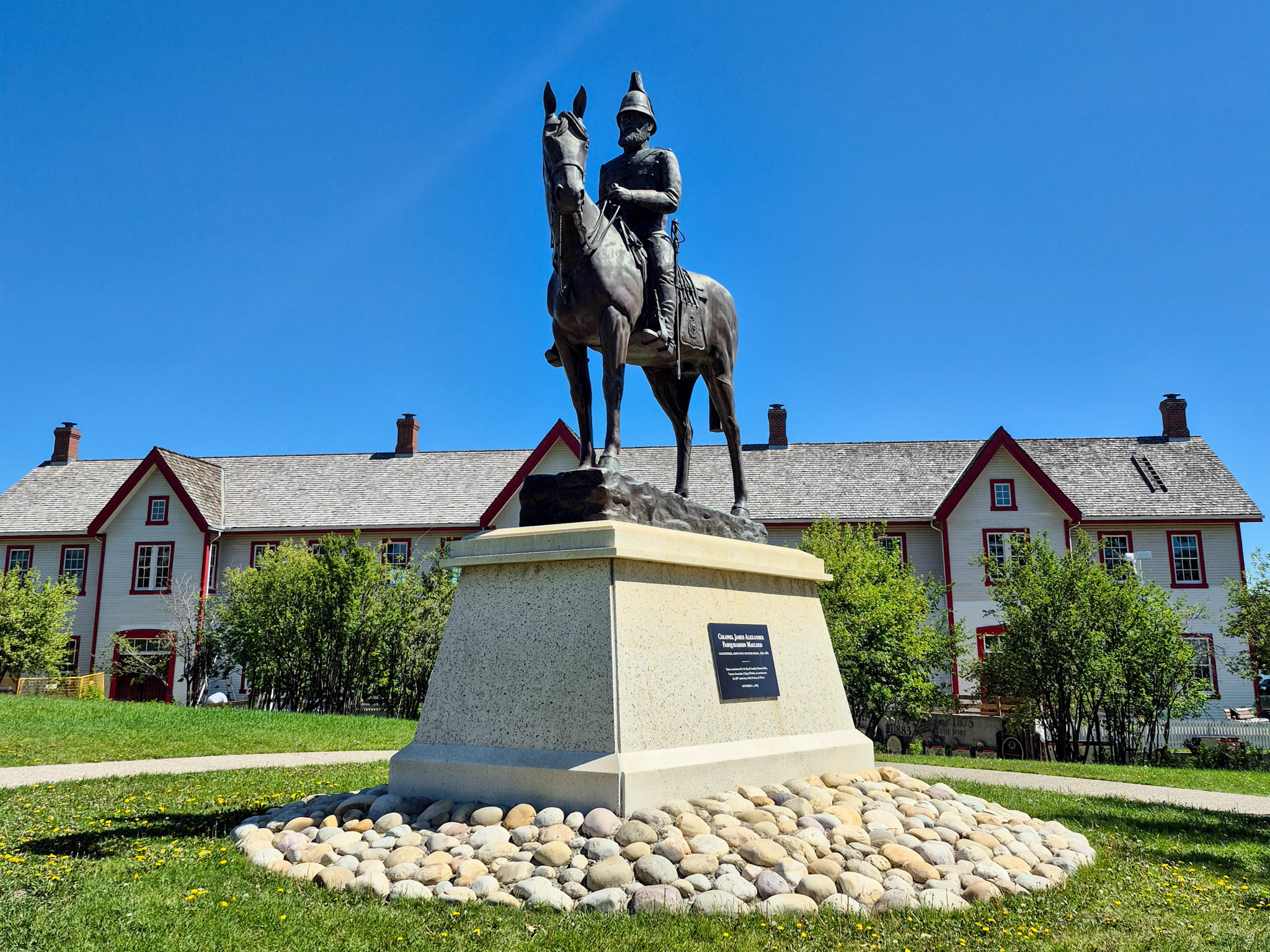 A statue of Colonel James Macleod on a horse in front of the Confluence building in Calgary.