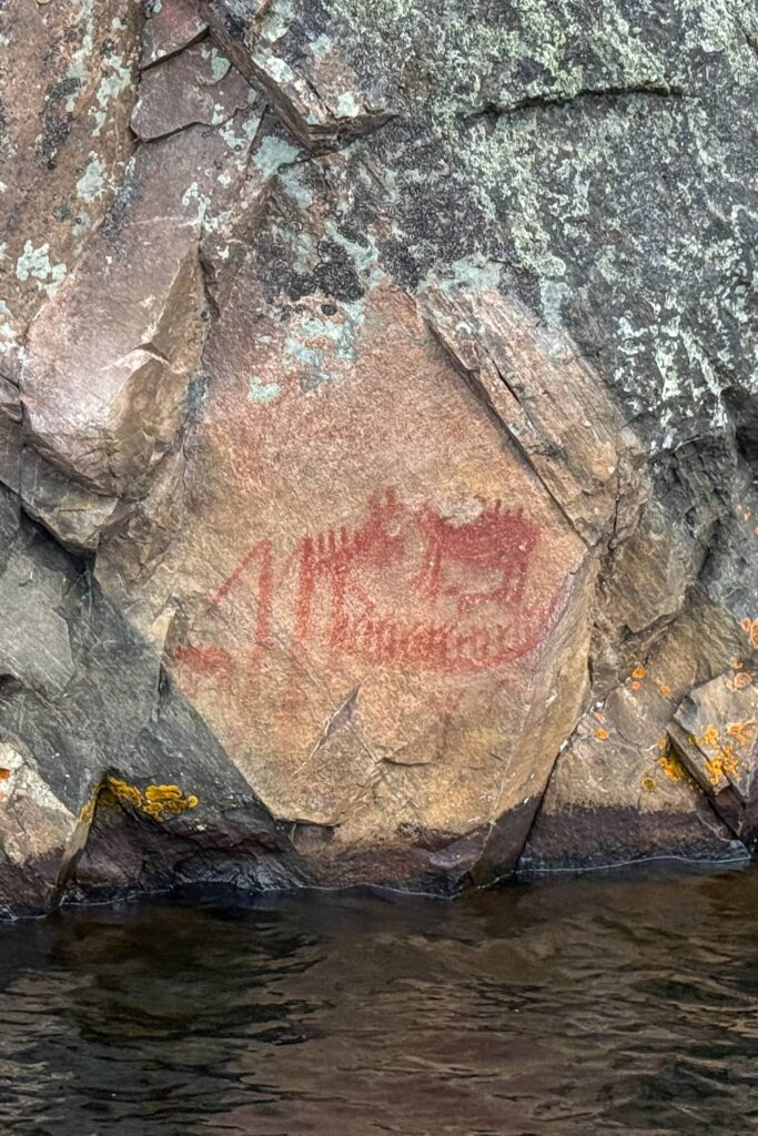 Mishipizheu, the underwater panther as a pictograph with a canoe pictograph