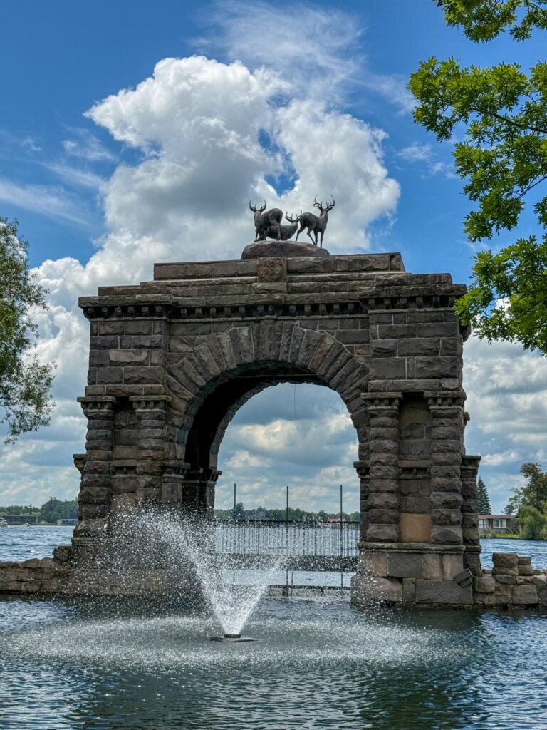 The Boldt Castle Entry Arch. It is a large stone arch inspired by Roman architecture. On top are 3 antlered deer.