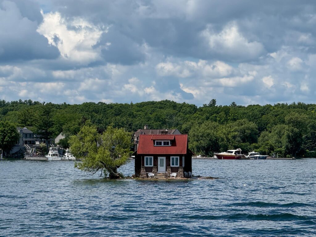 Just Room Enough Island as seen from the 1000 Islands Cruise. This small island has room for just a house and a tree.