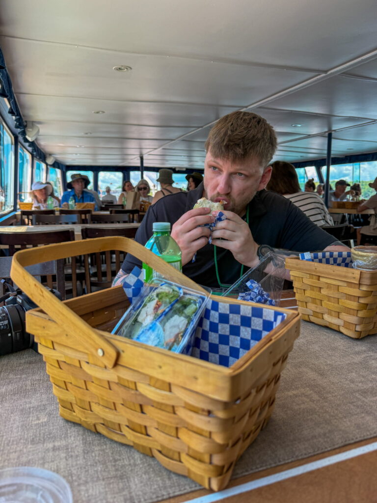 Justin biting into his Island Wrap on the 1000 Islands Cruise